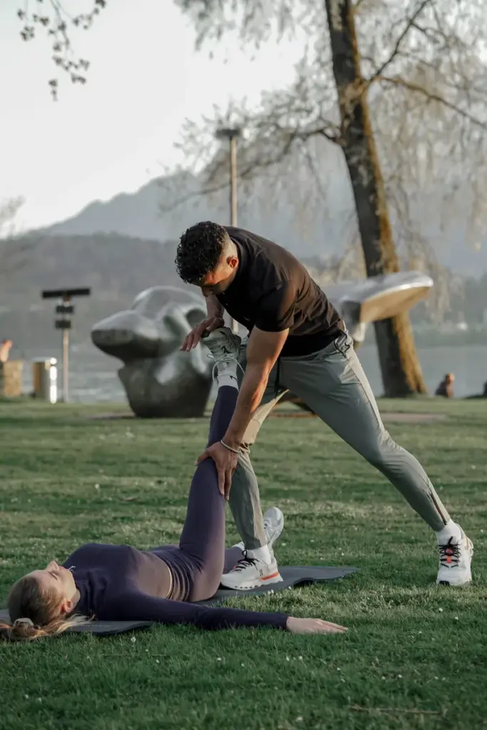 Personal Trainer Adil Semdaji applying his professional expertise during client stretching session