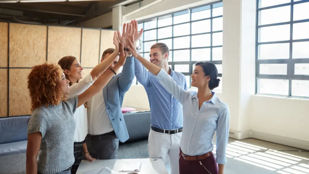 Employee wellness programs team building high five celebration coworkers success