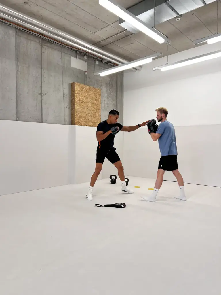 Personal Trainer indoor boxing session male client intensive training championship level instruction